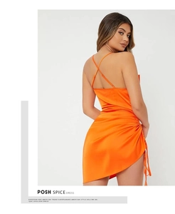 Dettaglio dell'abito in raso arancione con coulisse laterale e schiena scoperta