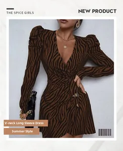 Detail of V-neck zebra print dress with puffed long sleeves and waist tie tie