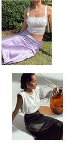 Detail view of elegant satin midi skirts in lilac and black with luxury glossy finish