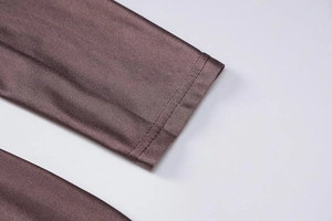 Close-up of ribbed long sleeve cuffs with double-needle stitching in purple-brown