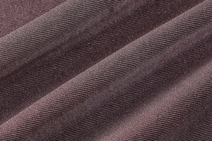 Close-up of high-elasticity ribbed knit fabric texture on a slim-fit dark purple mini dress