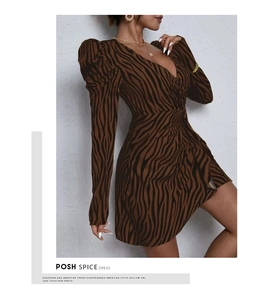 Detailed close-up of the zebra print fabric texture and flattering V-neckline tailoring