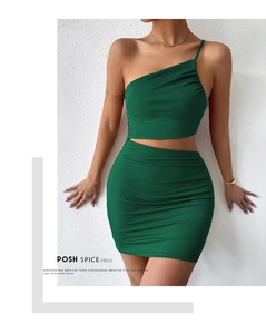 Close-up of dark green knitted dress with cut-out waist and ribbed texture detail