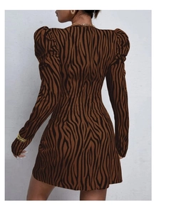 Rear view of long sleeve zebra print dress featuring puff sleeves and hidden zipper