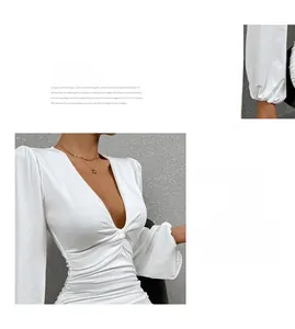 Détail d'une robe blanche col en V profond avec manches bouffantes et fronces