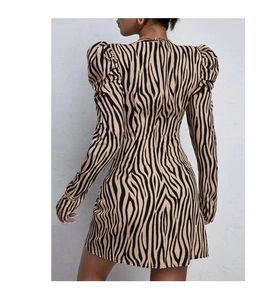 Detail view of women's zebra print knit dress with back invisible zipper and puff sleeves