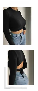 Detail of backless crop top featuring ribbed knit fabric and lace-up triangle cutout