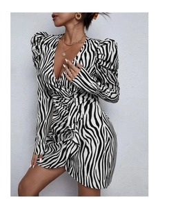Detail of zebra print knit dress featuring a deep V-neck and ruched long puff sleeves