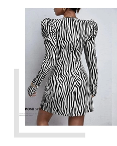 Detail of zebra print knit dress featuring puff sleeves and hidden back zipper closure