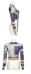 Detail view of cropped long-sleeve top with vintage print and side drawstring ruching