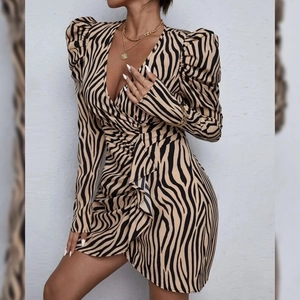 Zebra print V-neck knit dress with puff sleeves and ruffled details shown on model