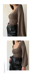 Detail shot of a slim-fit dark brown U-neck top and black faux leather high-waist trousers