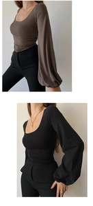 Detail view of U-neck black and brown slim fit long sleeve tops with lantern sleeves