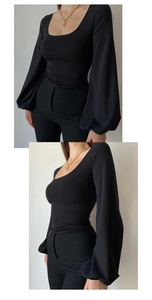 Detail view of black U-neck top featuring puff lantern sleeves and slim fit waist design