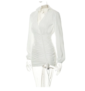 Detailed view of white V-neck mini dress showing textured pleats and adjustable side drawstring