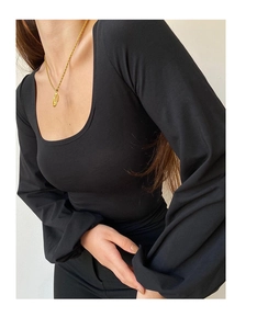Detail of black U-neck top featuring puffy lantern sleeves and knit texture design