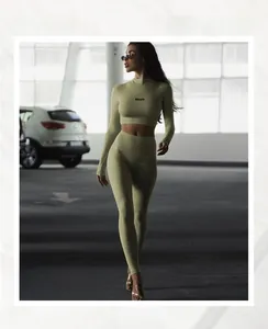Detail of olive green yoga set featuring BEAUTY text on long sleeve crop top and leggings