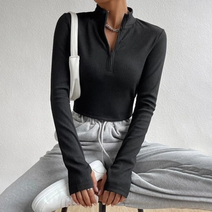 Slim fit black ribbed knit top with half-zip stand collar and long sleeves for women