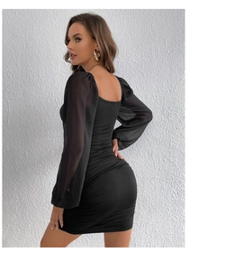 Detail of black bodycon dress featuring elegant ruching and sheer mesh puff sleeves