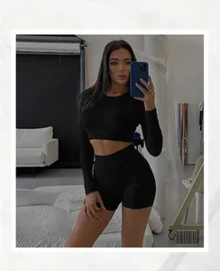 Detailed view of the ribbed fabric texture on a black long sleeve crop top and shorts set
