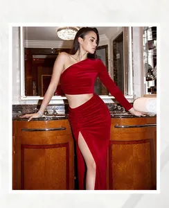 Detail view of the red velvet dress featuring a side waist cutout and high leg slit