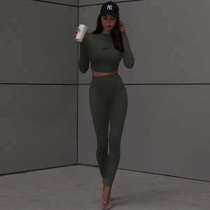 Women's slim fit dark grey long sleeve crop top and yoga leggings set with BEAUTY text