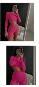 Detailed close-up of pink ribbed knit texture on slim-fit long sleeve top and shorts set