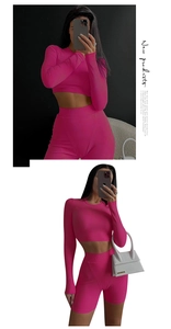 Detail of ribbed knit crop top and high-waist shorts set in vibrant rose pink color