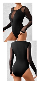 Detailed view of black bodysuit featuring sheer mesh panels and long sleeves with V-neckline