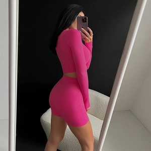 Chic hot pink ribbed knit two-piece set featuring long sleeve crop top and high waist mini skirt