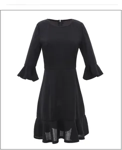 Detail of ruffle sleeve and hem on black round neck midi dress with elegant drape