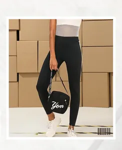 Detailed view of high waist yoga leggings with letter print handbag and white sneakers