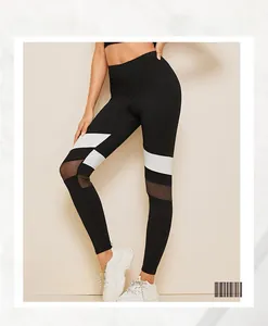 Detail of color-block yoga pants with breathable black mesh panels and high elasticity