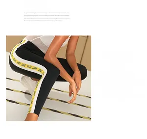Close-up of LOVE letter print and side stripe detail on high waist sports leggings