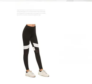 Detail of color-block yoga leggings featuring white side stripes and breathable mesh panels