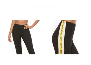 Detail view showing black high-waisted yoga pants with white LOVE lettered side stripes