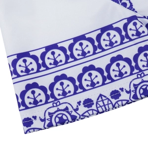 Close-up of ethnic geometric floral print on breathable white fabric with neat stitching