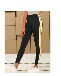 Detail of black high waist leggings with yellow LOVE letter print on side tape
