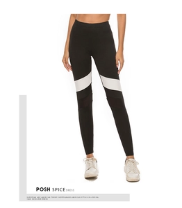 Detailed view of women's yoga leggings featuring black mesh panels and white color-block patterns
