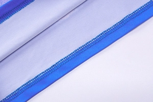Detail of professional overlock stitching on 3D print bodycon dress fabric seams