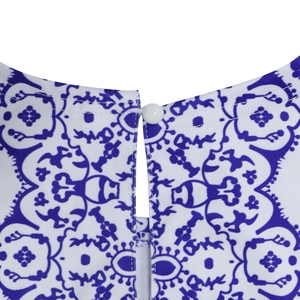 Macro detail of white resin button with elastic loop on ethnic blue print dress