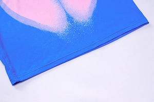 Detail of royal blue 3D heart print dress showing hemline stitching and fabric texture