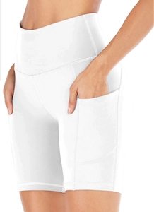Detail view of white high-waisted yoga shorts featuring functional side pockets and reinforced seams