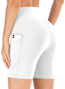 Detail view of white high-waisted yoga shorts with side pocket showing phone storage