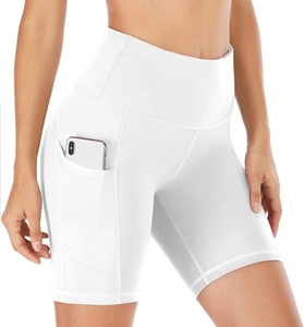 Detailed view of functional side pocket on high-waisted white yoga shorts with smartphone