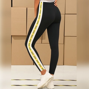 Women's black high-waist yoga leggings with love print side stripes and push-up effect