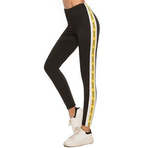 Women's black high waist yoga pants with yellow and white LOVE printed side stripes