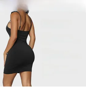 Detailed view of the 3D cut and elastic fabric on this slim fit black mini dress