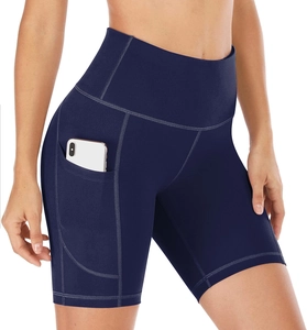 Detail of high-waisted yoga shorts in dark blue with a functional side phone pocket