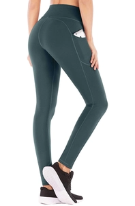 Detail shot of high-waisted dark green yoga leggings with functional side phone pocket